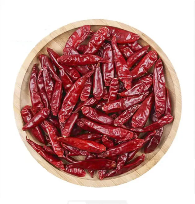 Whole dried red chilies in a woven tray